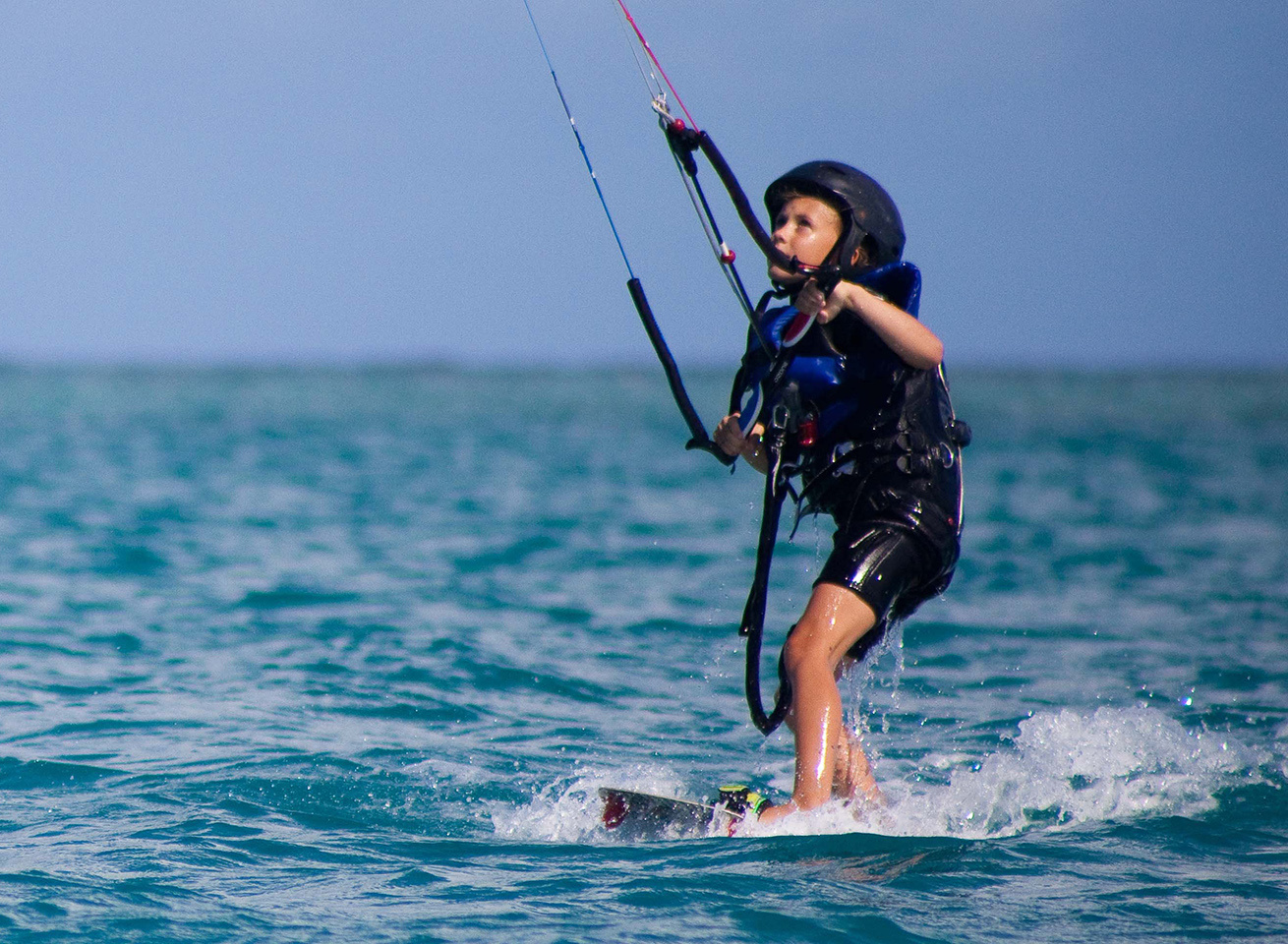 child learning kitesurfing in antigua at 40knots caribbean